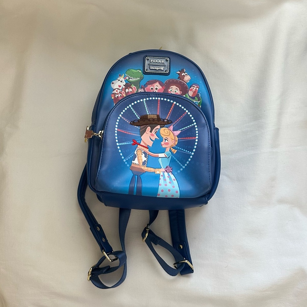 LOUNGEFLY PIXAR MOMEMT TOY STORY WOODY, BO PEEP, & TOYS BACKPACK